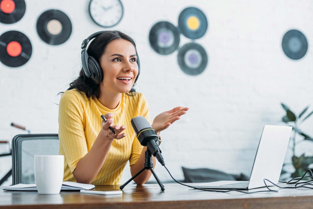 smiling-radio-host-gesturing-while-recording-podca-ZE4F34T.jpg