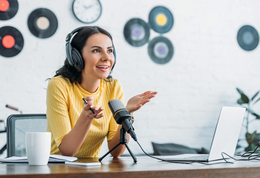 smiling-radio-host-gesturing-while-recording-podca-ZE4F34T.jpg