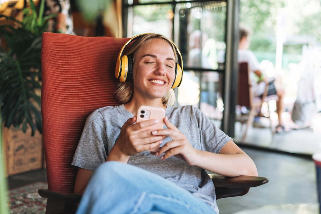 young-happy-woman-with-close-eyes-in-yellow-headph-C2TKXC2.jpg