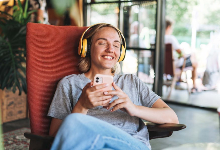 young-happy-woman-with-close-eyes-in-yellow-headph-C2TKXC2.jpg