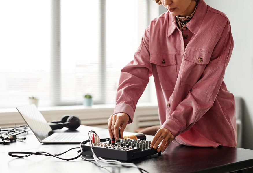 young-woman-setting-up-audio-equipment-UCEFGBD.jpg